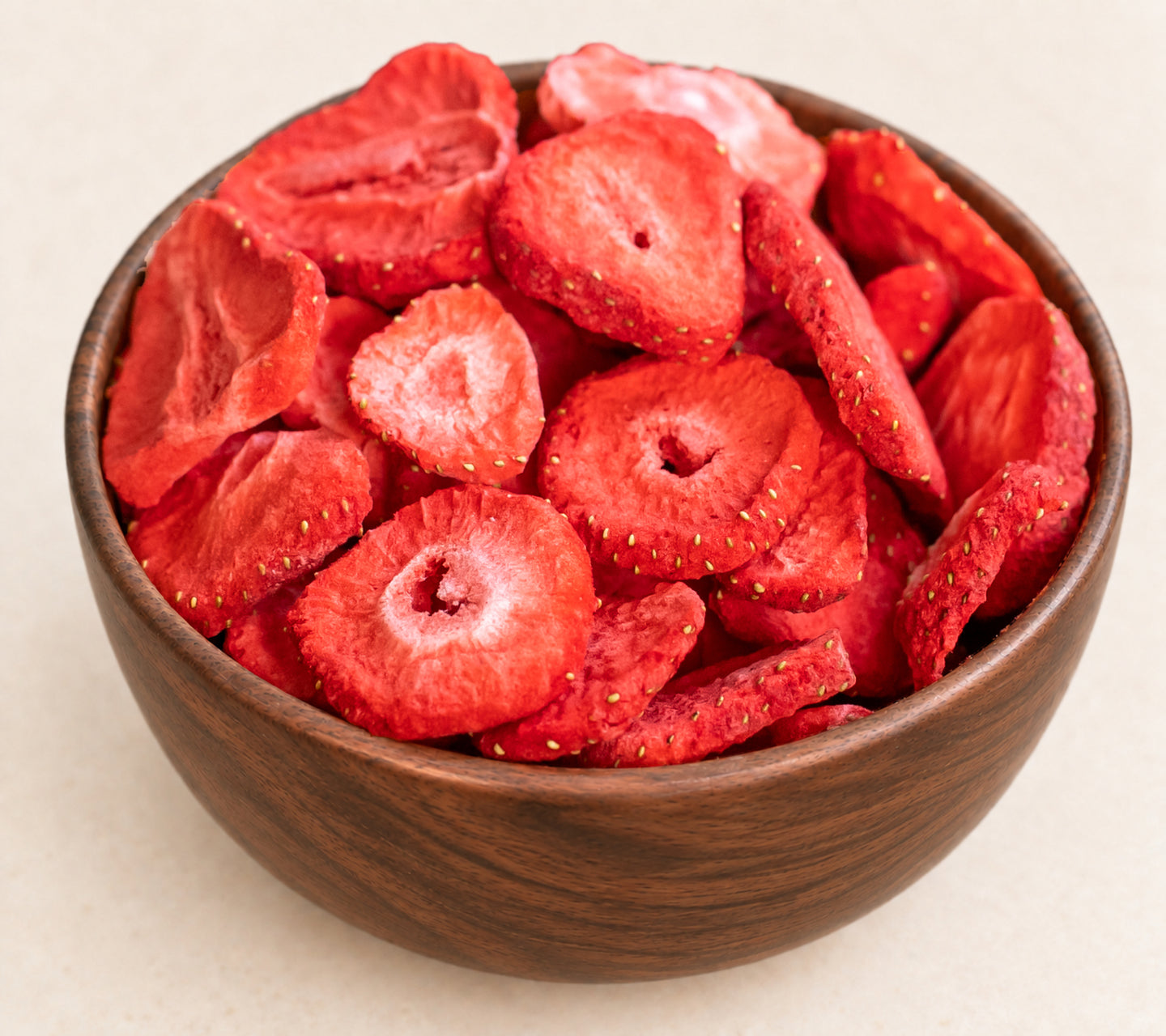 Close-up of the actual strawberry slices, showing visible seeds and naturally varied cut surfaces, in the approved walnut bowl composition.